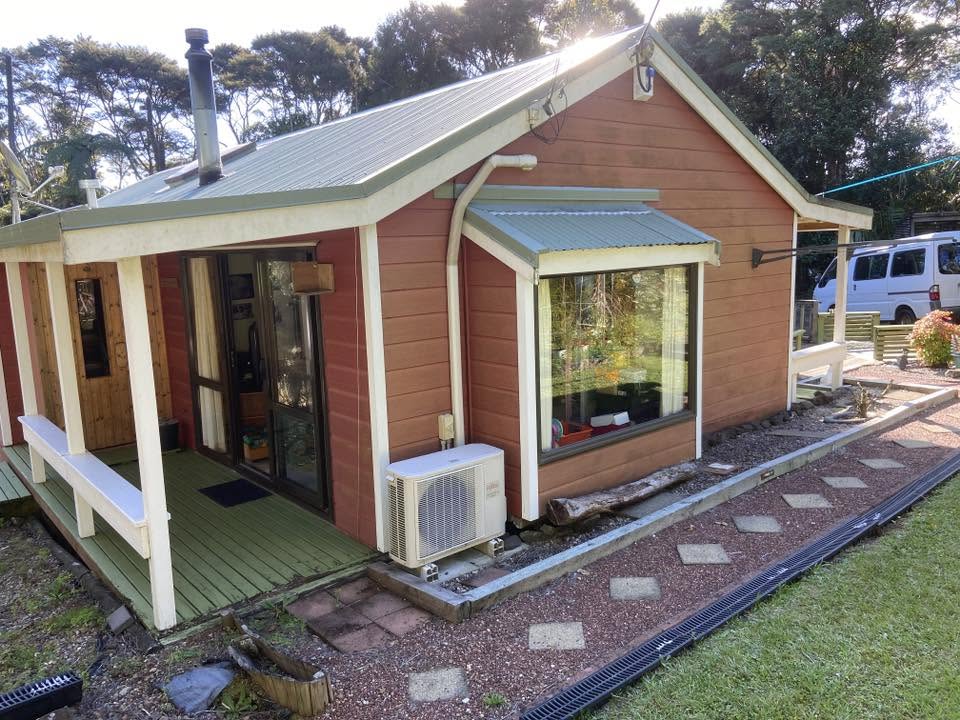 Repainted timber-clad house with a covered porch